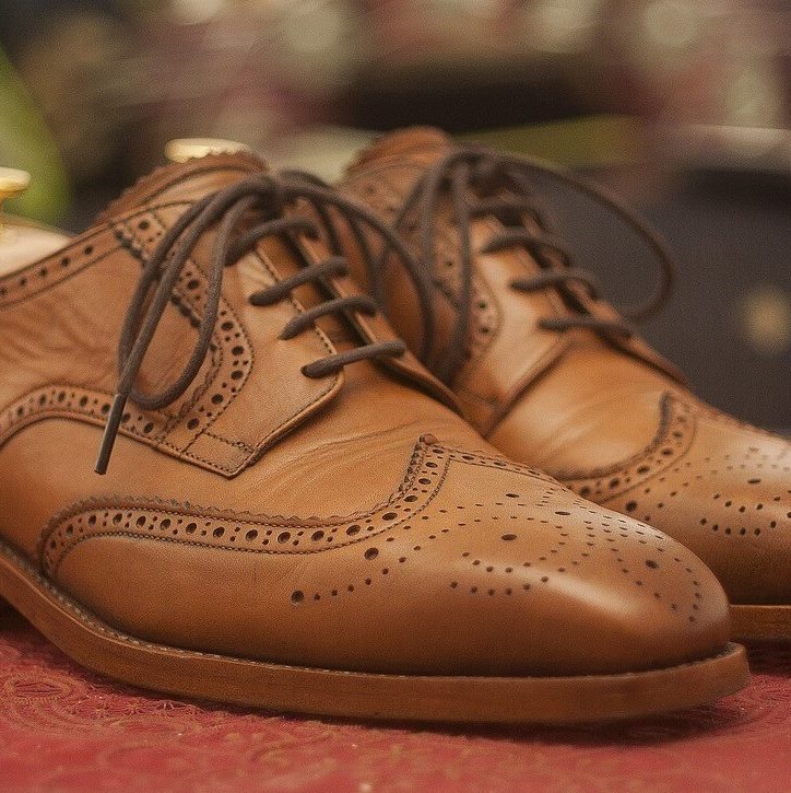 man's chestnut leather wing-tip oxford shoes