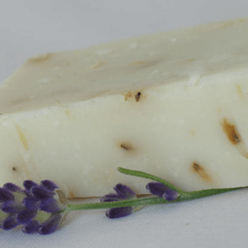 Lavender Castile soap bar with lavendar flower buds in the soap and a lavender flower stalk for decoration